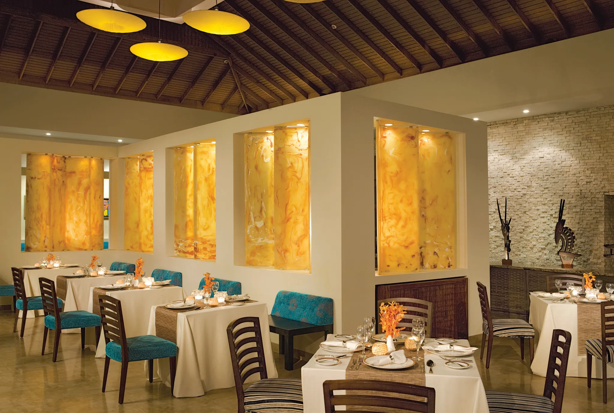 Blue Mountain restaurant at Secrets St. James Montego Bay featuring elegant Caribbean-inspired dining room with warm lighting, modern décor, and intimate table settings.
