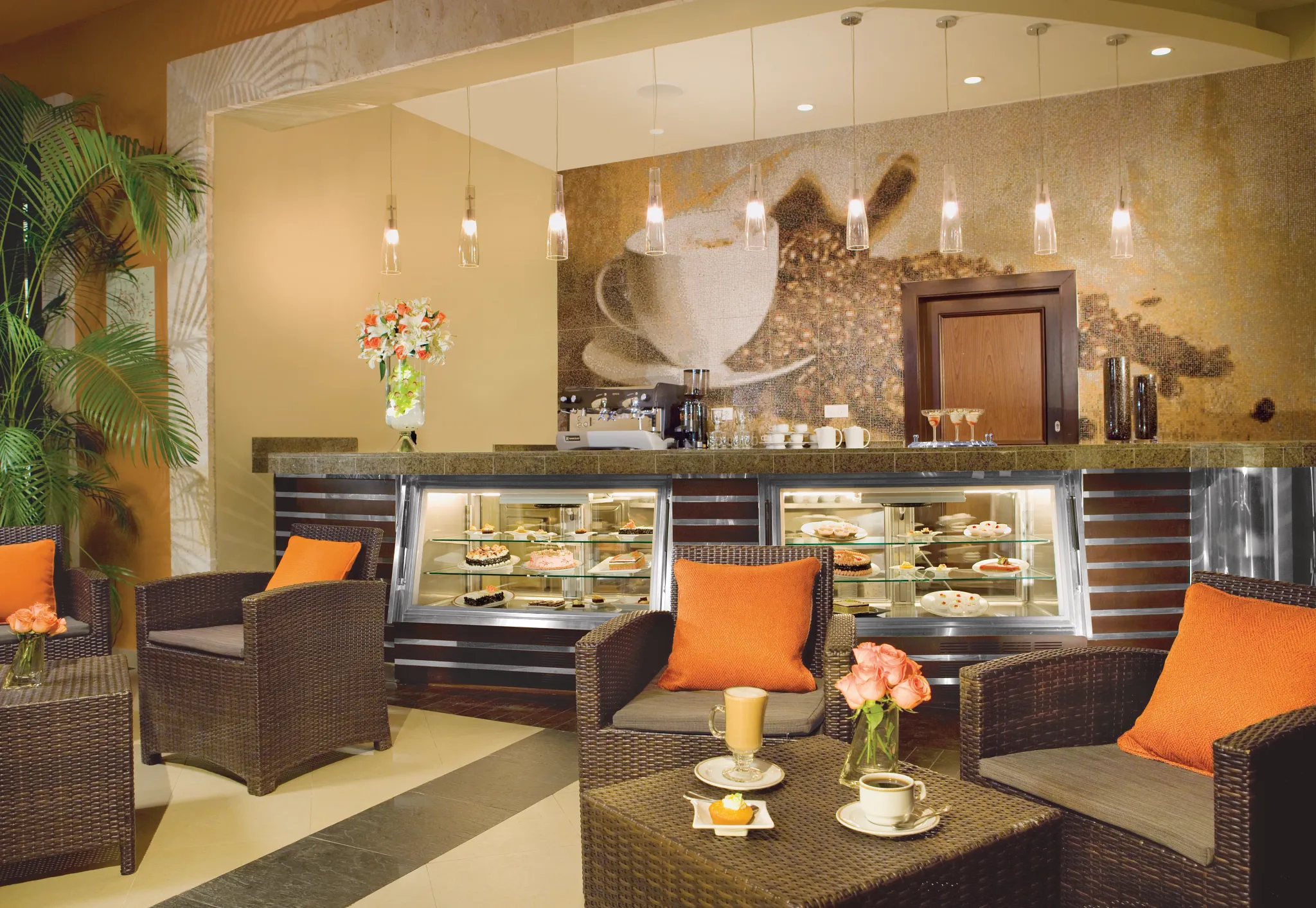 Coco Café at Secrets St. James Montego Bay featuring a cozy coffee bar with pastries, espresso drinks, dessert display, and comfortable lounge seating.