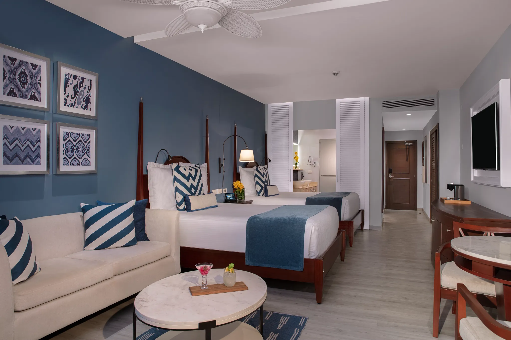 Junior Suite Ocean View with two queen beds, sitting area, and modern décor at Secrets St. James Montego Bay.