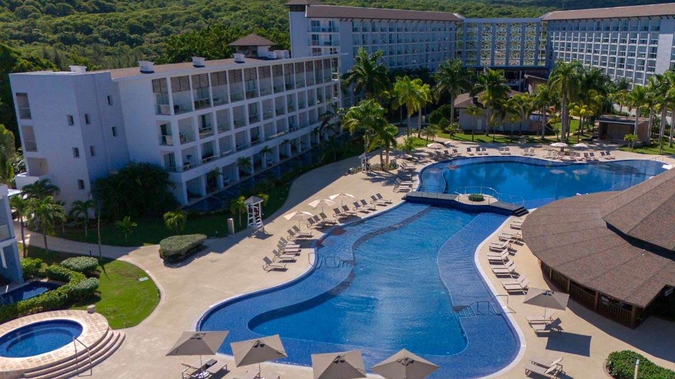 Royalton Blue Waters Montego Bay all-inclusive resort in Jamaica with overwater bungalows, family pools, and modern Caribbean luxury.