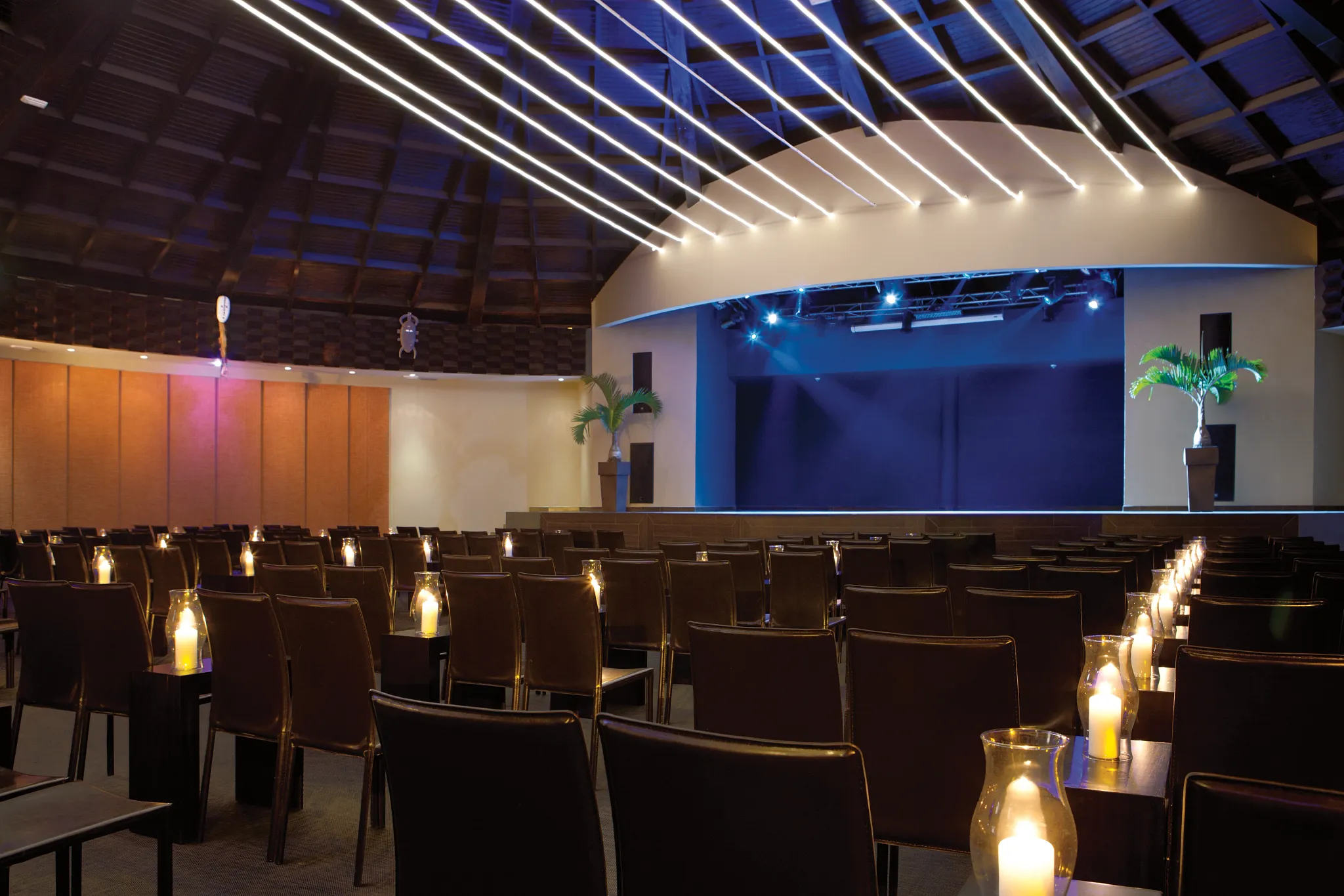 Indoor theater with stage lighting and seating at Secrets St. James Montego Bay for nightly entertainment.
